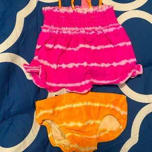 Pink and Orange bikini for baby. Looks like tye dye.